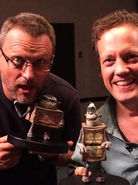Steve Blum and Dee Bradley Baker holding figures of their characters from The Boxtrolls