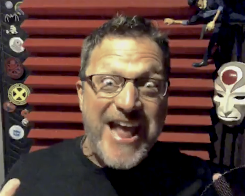 Steve Blum at the microphone making a silly face with red foam behind