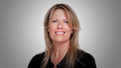 Grey background headshot of Mary Elizabeth McGlynn