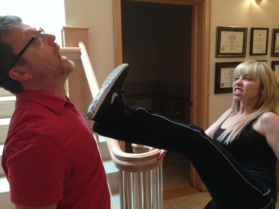 Voice actor Tara Strong kicking Steve Blum in the face in a silly way